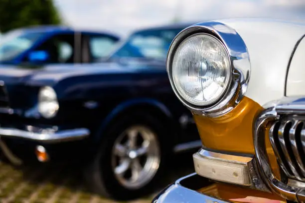 Photo of Chrome plated front lamp of a restored classic car.