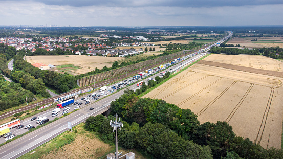 Weilbach, Germany - July 16, 2021: Dense traffic due to high traffic volume and rest area Weilbach on German highway A3 nearby Wiesbaden. Drone point of view