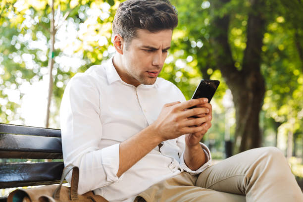istock Disappointed young businessman sitting on a bench 1329498633