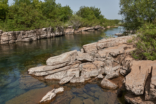Quiet river stream along the tectonic rocks