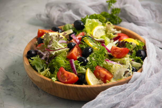 istock fresh salad, tomatoes, olives on a concrete background 1329499479