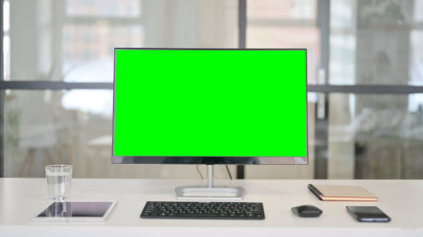 istock Close Up of Desktop with Green Chroma Key Screen 1329501048