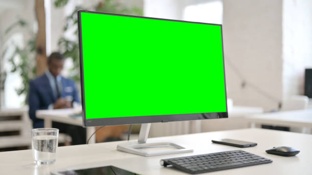 istock Close Up of Desktop with Green Chroma Key Screen 1329501221