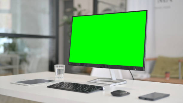 istock Close Up of Desktop with Green Chroma Key Screen 1329501236