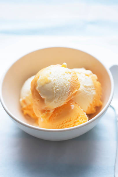 istock Orange and cheese ice creams in bowl 1329502646
