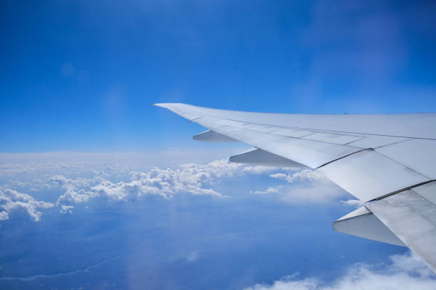istock Airplane wing on the blue sky 1329503537