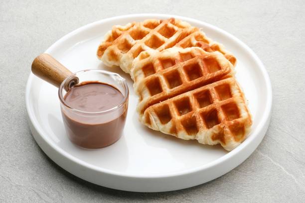 croissant waffle or croffle with chocolate sauce served in plate. - cafe buns eating bildbanksfoton och bilder