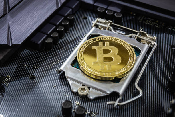 istock Close up of Golden bitcoin on CPU socket in computer. Crypto Currency concept and online trading of blockchain backed digital money popular nowadays. Background copy space 1329504741