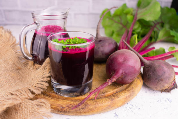 istock Beet juice in a glass and a decanter and fresh beets. Detox drinks concept. 1329504821
