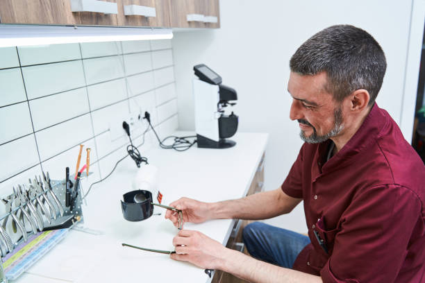 istock Bearded male optician with glasses working in optical workshop 1329505020