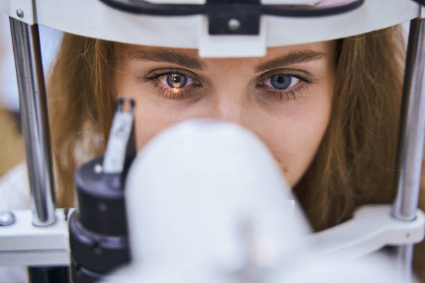 istock Young woman having eyesight examining in clinic 1329505047