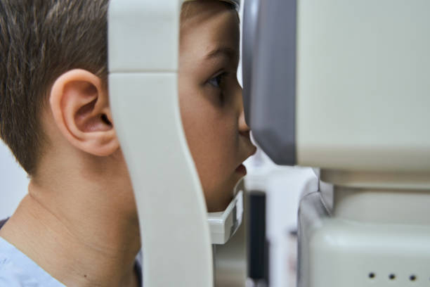 istock Cute little boy having eye examining in clinic 1329505059