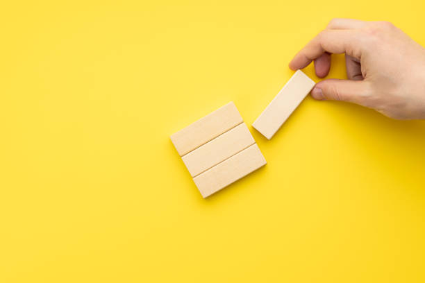 istock blank wooden blocks stack over yellow background. business strategy template. step notes mockup. above view 1329506110