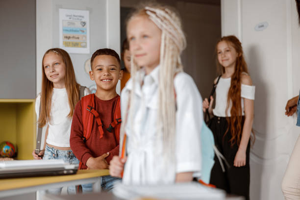 istock Smiling kids standing in class at school 1329507630