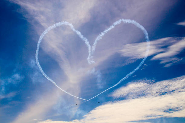 istock Heart shaped smoke from aerobatic planes 1329509271