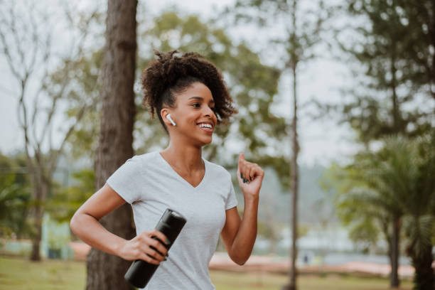 istock woman running in the park 1329510396