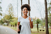 istock woman running in the park 1329510401
