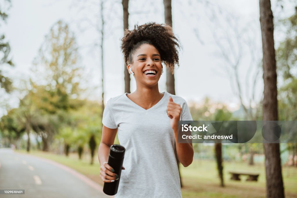 woman running in the park Running Stock Photo