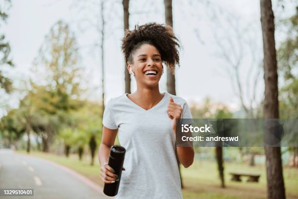 Woman Running In The Park Stock Photo - Download Image Now - Running, Exercising, Women