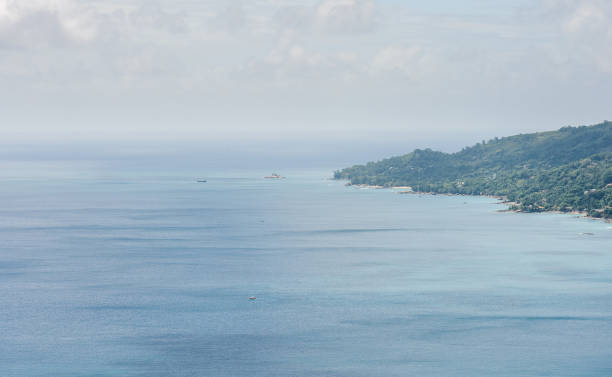istock Beach in Seychelles with Ocean Water and Blue Sky with Clouds. Landscape. 1329510433