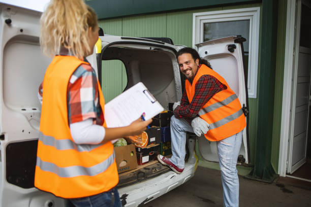 istock Two people a young man and a girl,work in a fruit and vegetable warehouse. 1329512786