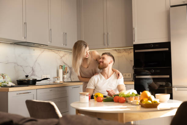 istock Smiling european couple on kitchen at home 1329513022