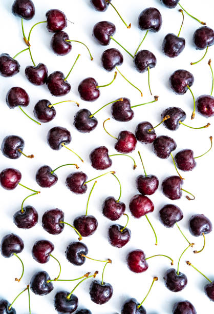 istock Cherry fruits fresh with dew water drops isolated on white 1329514230