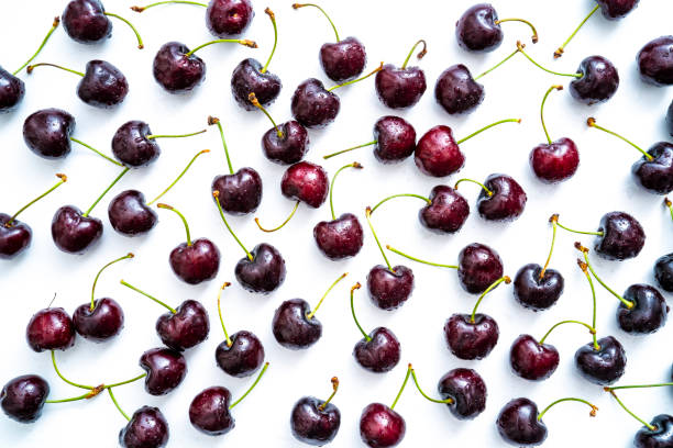 istock Cherry fruits fresh with dew water drops isolated on white 1329514569