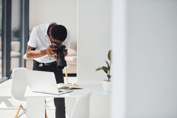 istock Testing camera. Young african american man in formal clothes is in the office 1329514661