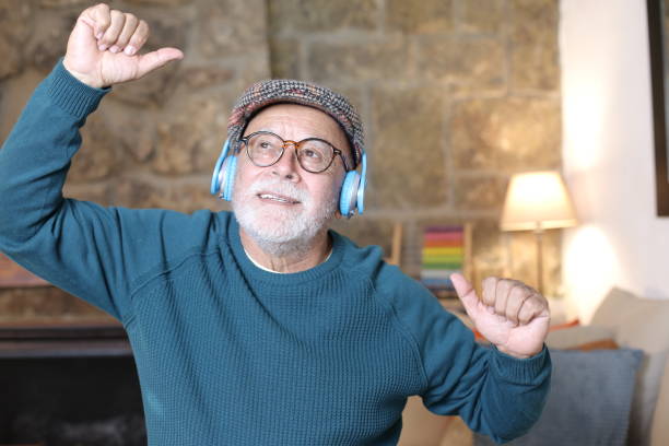 istock Senior man dancing with headphones 1329516407