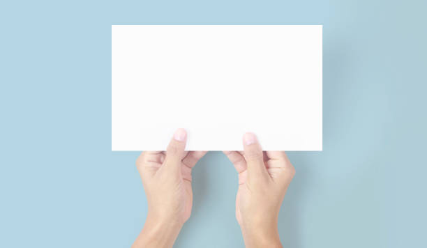 istock Hands holding paper blank for letter paper 1329516597
