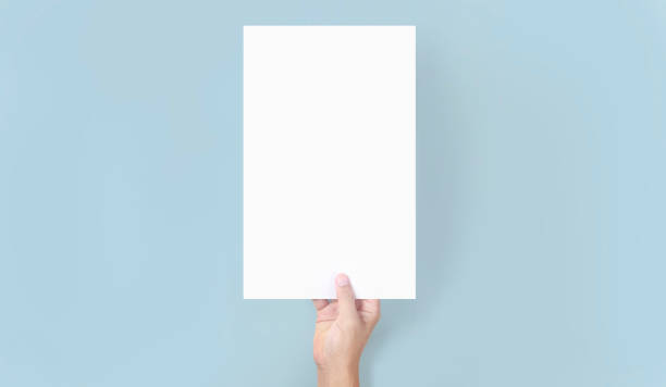 istock Hands holding paper blank for letter paper 1329516598