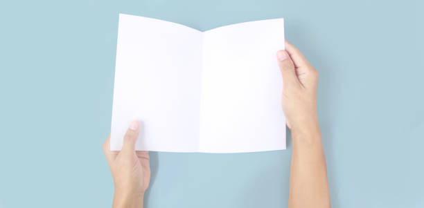 istock Hands holding paper blank for letter paper 1329516611