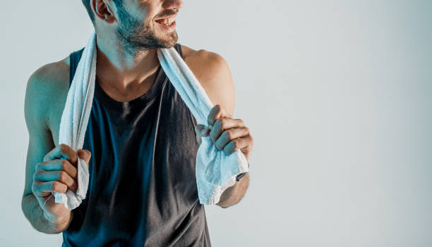 istock Smiling young sportsman with towel in studio 1329516994