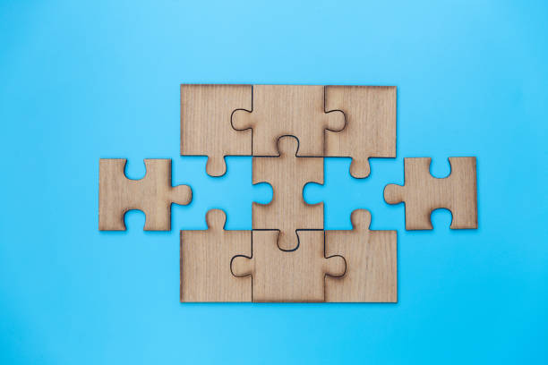 istock Unfinished jigsaw puzzle pieces on blue background,  Copy space. 1329517123