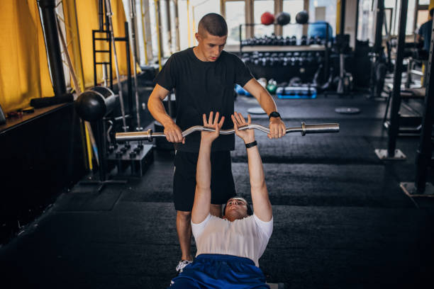 istock Man exercises with fitness trainer 1329518660