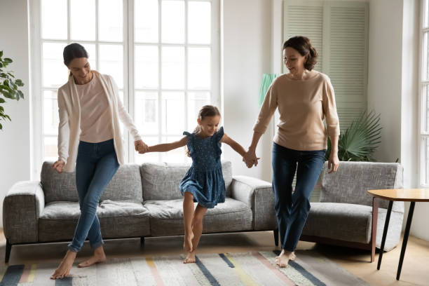 istock Happy three generations of women relax dancing together 1329519499