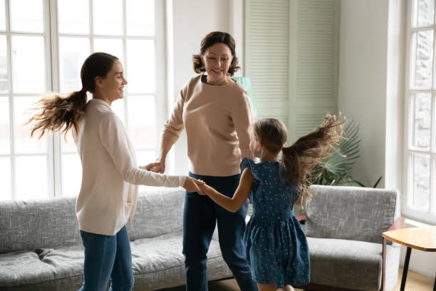 istock Smiling three generations of women dance at home 1329519500