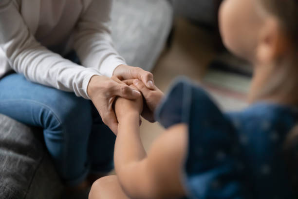 istock Close up of caring mom hold small daughter hands 1329519530