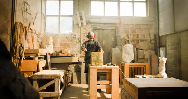 istock Stonemason drawing outline on a block of stone 1329520118