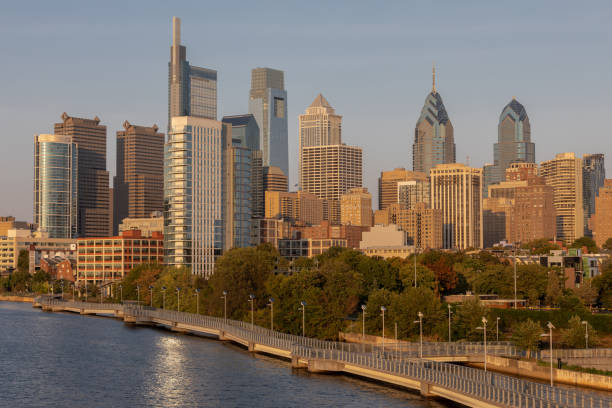 istock Philadelphia Downtown skyline with the Schuylkill river. Beautiful Sunset Light. Schuylkill River Trail in Background. City skyline glows under the beautiful sunset light 1329520126