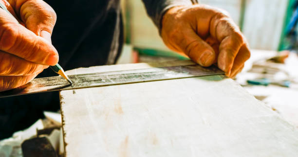istock Stonemason drawing outline on a block of stone 1329520186