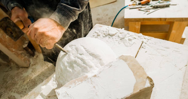 istock Stonemason carving a sculpture in the workshop 1329520243