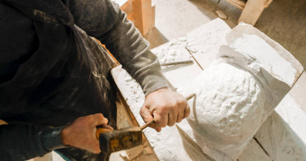 istock Stonemason carving a sculpture in the workshop 1329520252