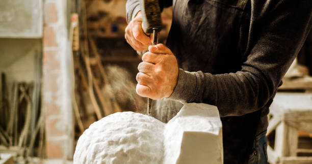 istock Stonemason carving a sculpture in the workshop 1329520296