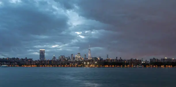 NYC Cityscape with Stormy Cloudy Blue Sky in Background. Late Autumn Skyline