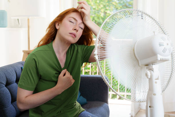 istock One woman suffering for summer heatwave at home 1329521232