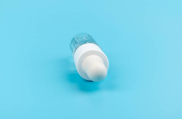 istock face serum drop with bottle on blue background. 1329521753