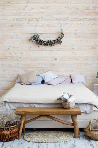istock Light bohemian bedroom with wooden wall 1329522550