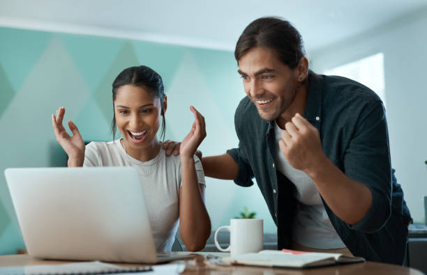 istock Shot of a young couple using a laptop at home 1329523064